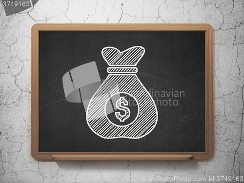 Image of Business concept: Money Bag on chalkboard background