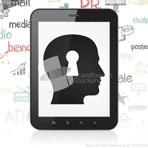 Image of Advertising concept: Tablet Computer with Head With Keyhole on display