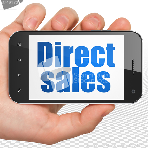 Image of Marketing concept: Hand Holding Smartphone with Direct Sales on display