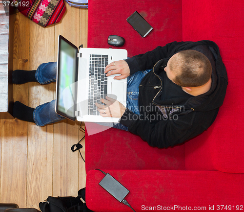 Image of High angle view of a man using his laptop