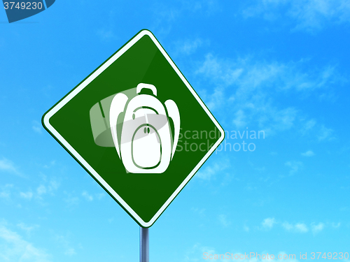 Image of Learning concept: Backpack on road sign background