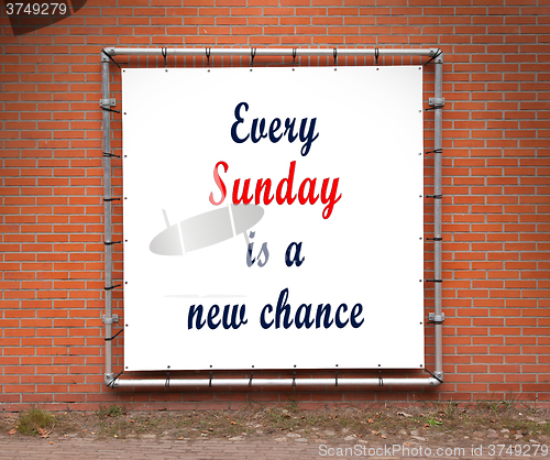 Image of Large banner with inspirational quote on a brick wall