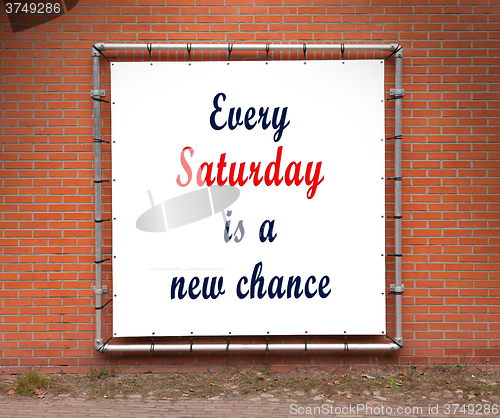 Image of Large banner with inspirational quote on a brick wall