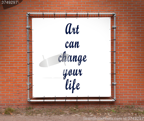 Image of Large banner with inspirational quote on a brick wall