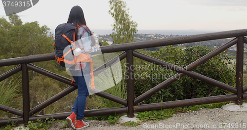 Image of Young woman with a backpack admiring the scenery