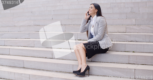 Image of Happy woman talking on phone