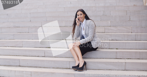 Image of Happy woman talking on phone