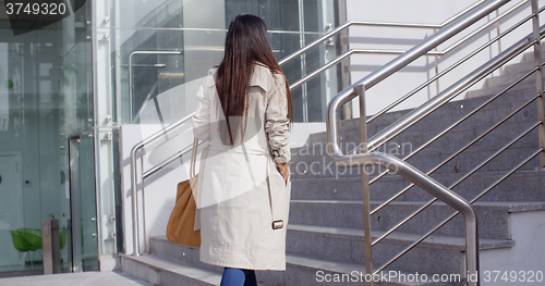 Image of Elegant woman walking through town