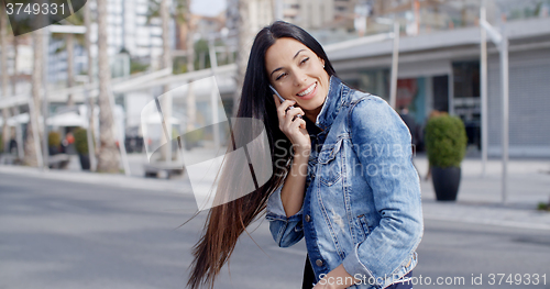 Image of Happy casual young woman swinging her hair