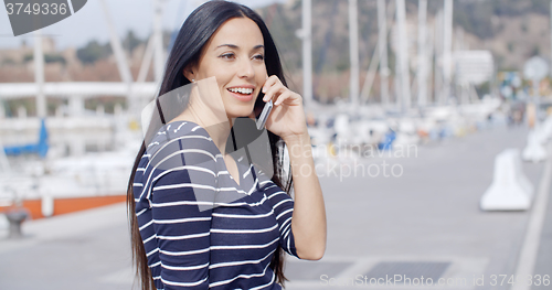 Image of Young woman on a seafront promenade