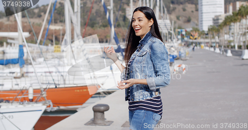 Image of Attractive casual young woman standing laughing