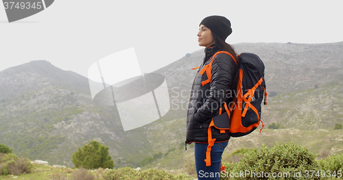 Image of Happy smiling woman enjoying a misty hike