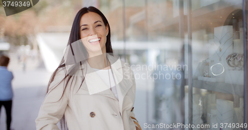 Image of Laughing vivacious woman in a town street