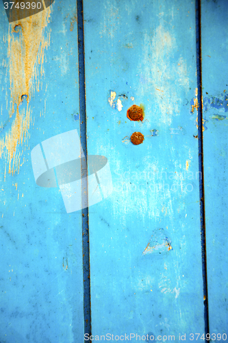 Image of dirty   paint in the blue wood  and rusty nail