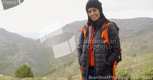 Image of Happy smiling woman enjoying a misty hike