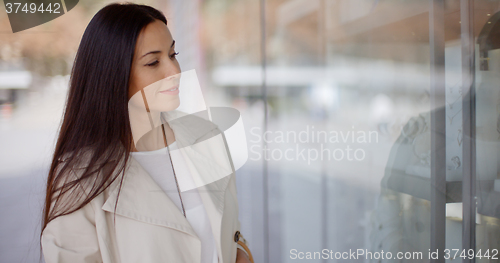 Image of Young woman eyeing an item for sale