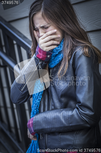 Image of Young Crying Teen Aged Girl on Staircase