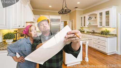 Image of Contractor Discussing Plans with Woman Inside Custom Kitchen Int