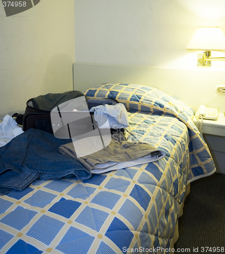 Image of hotel room with open suitcase