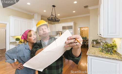 Image of Contractor Discussing Plans with Woman Inside Custom Kitchen Int