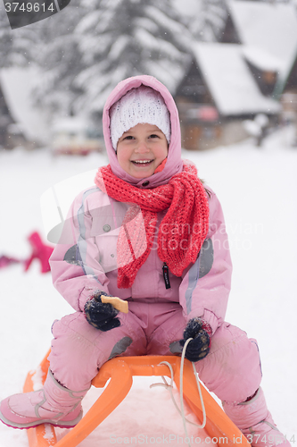 Image of little girl sitting on sledges