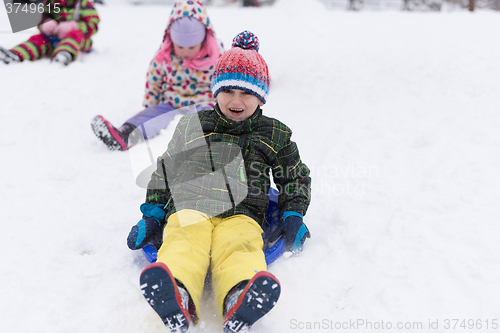 Image of group of kids having fun and play together in fresh snow