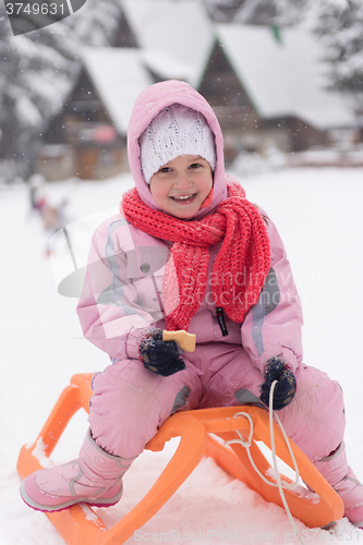 Image of little girl sitting on sledges