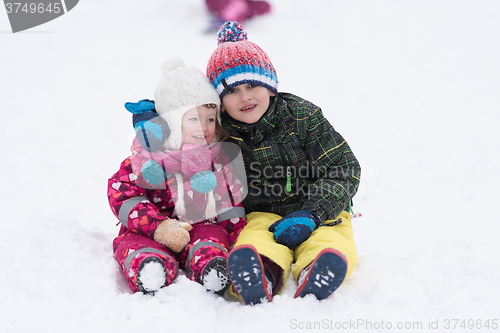 Image of group of kids having fun and play together in fresh snow