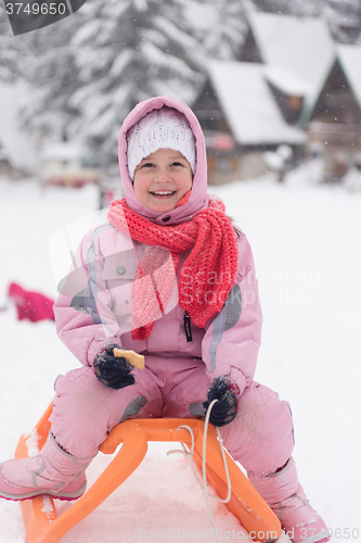 Image of little girl sitting on sledges