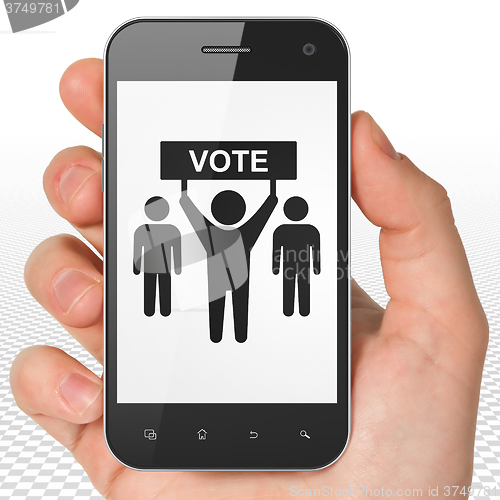 Image of Political concept: Hand Holding Smartphone with Election Campaign on display