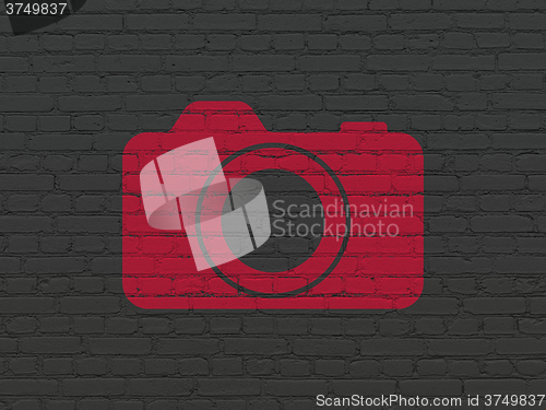 Image of Travel concept: Photo Camera on wall background