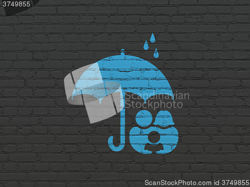 Image of Safety concept: Family And Umbrella on wall background