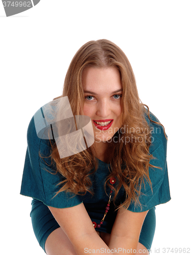 Image of Sitting woman smiling in closeup.