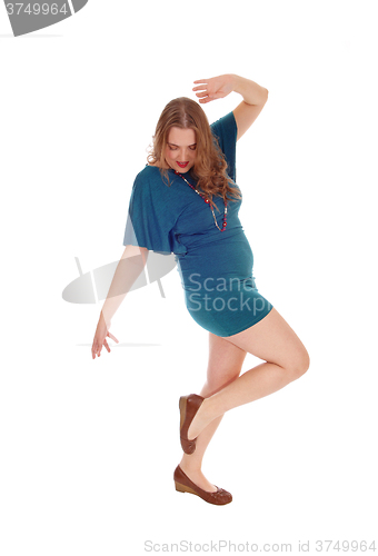 Image of Woman dancing is dress.