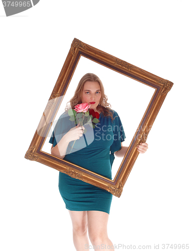 Image of Woman looking trough picture frame