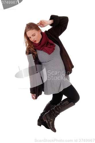Image of Lovely woman in winter coat dancing.