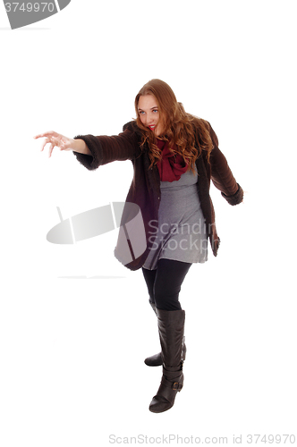 Image of Young woman in coat and boots.