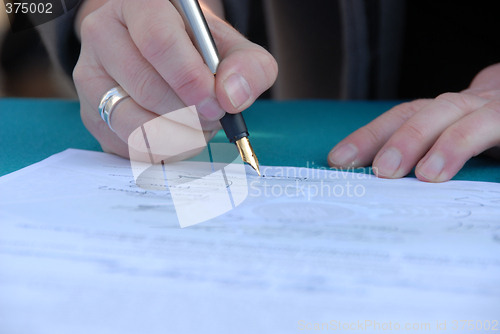 Image of Businessman is signing a contract