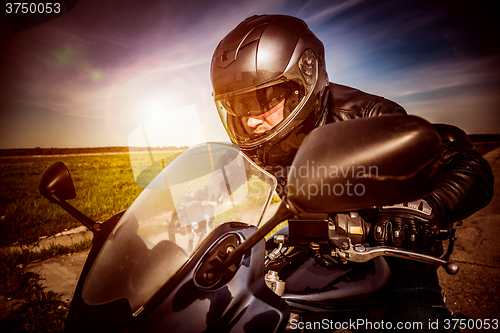 Image of Biker racing on the road