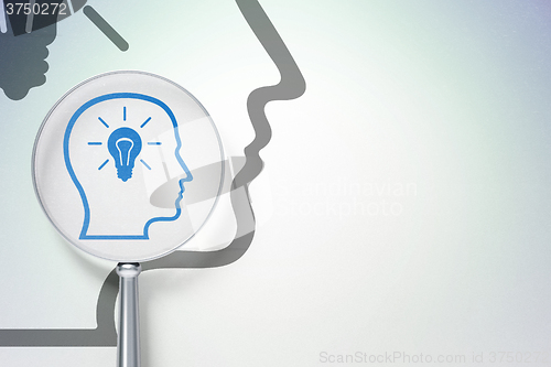 Image of Marketing concept:  Head With Lightbulb with optical glass on digital background