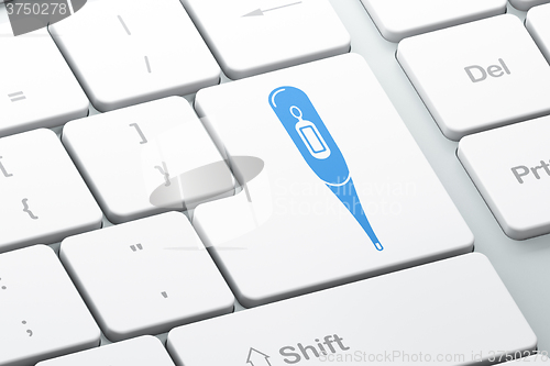 Image of Healthcare concept: Thermometer on computer keyboard background