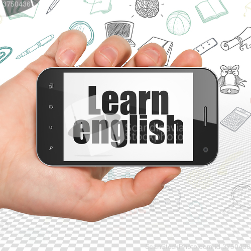 Image of Studying concept: Hand Holding Smartphone with Learn English on display