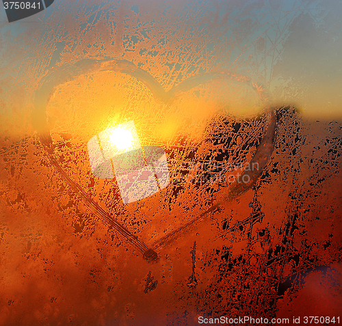 Image of Heart drawn on the frozen winter window