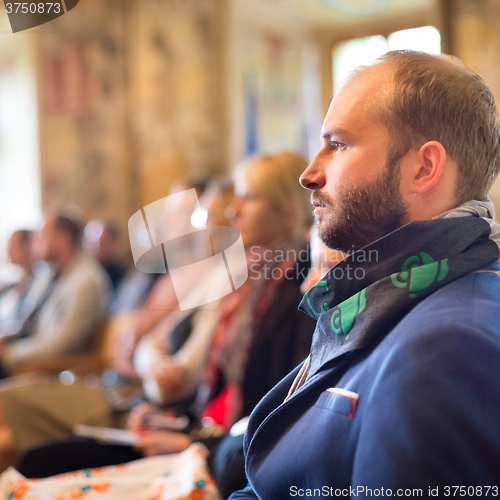 Image of Entrepreneur in audience at business conference.