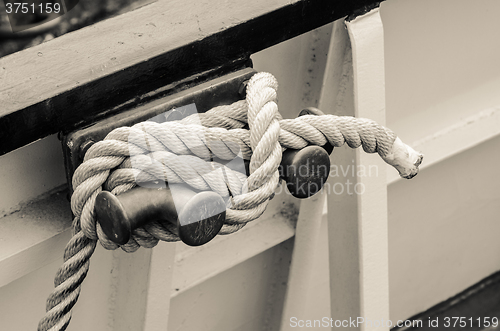 Image of Rope tied to bollard sailboat, sepia