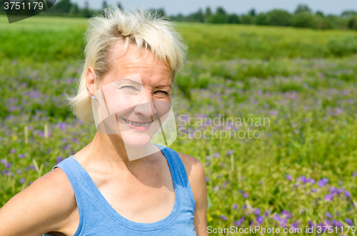 Image of Portrait of a woman amid the summer meadows in the countryside  