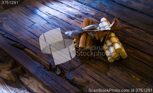 Image of Cinnamon sticks on wooden background