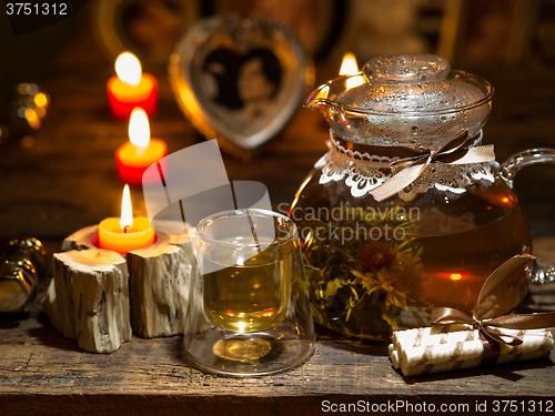 Image of The exotic green tea with flowers in glass teapot 