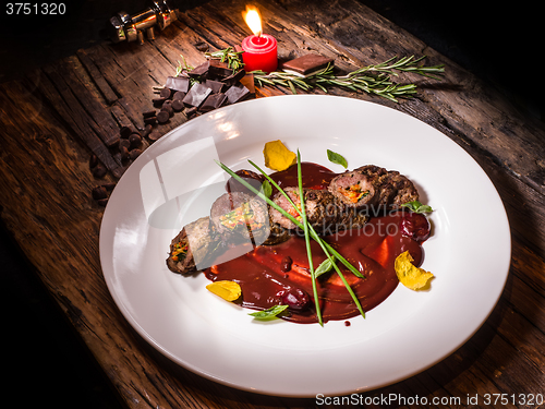 Image of Roasted meat with vegetables and chocolate sauce