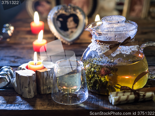 Image of The exotic green tea with flowers in glass teapot 